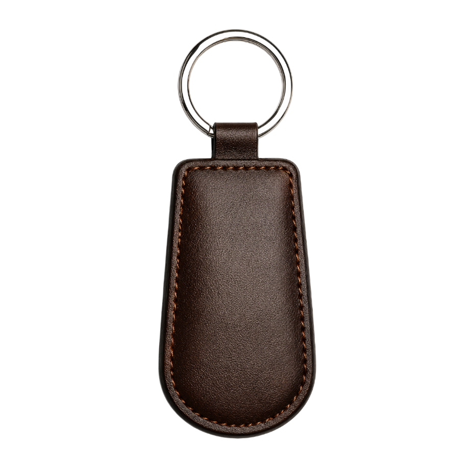 Brown leather keychain with a silver ring on a light gray background