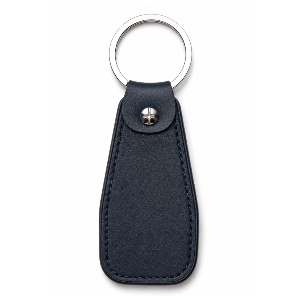Navy blue leather keychain with silver ring and metal clip on a white background